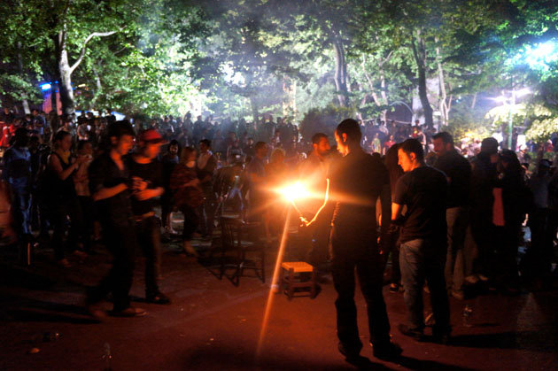 a crowd gathered around a fire