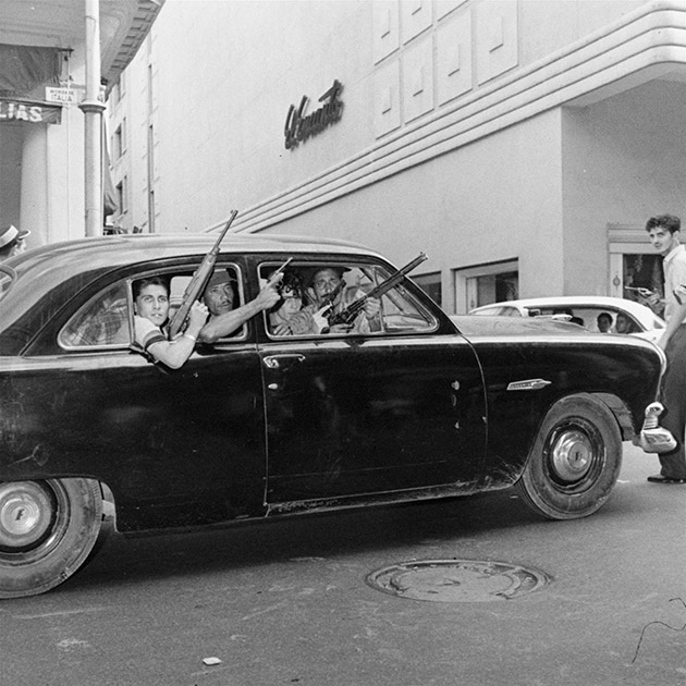 These young rebels are shown training a variety of weapons out windows of one of numerous cars that ranged Havana's streets, January 2, 1959, in the unrest attending plans for inaugurating a revolutionary government.