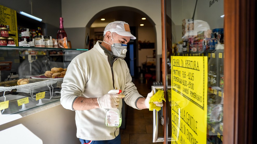 Person wipes down door handle in Cologno, Italy