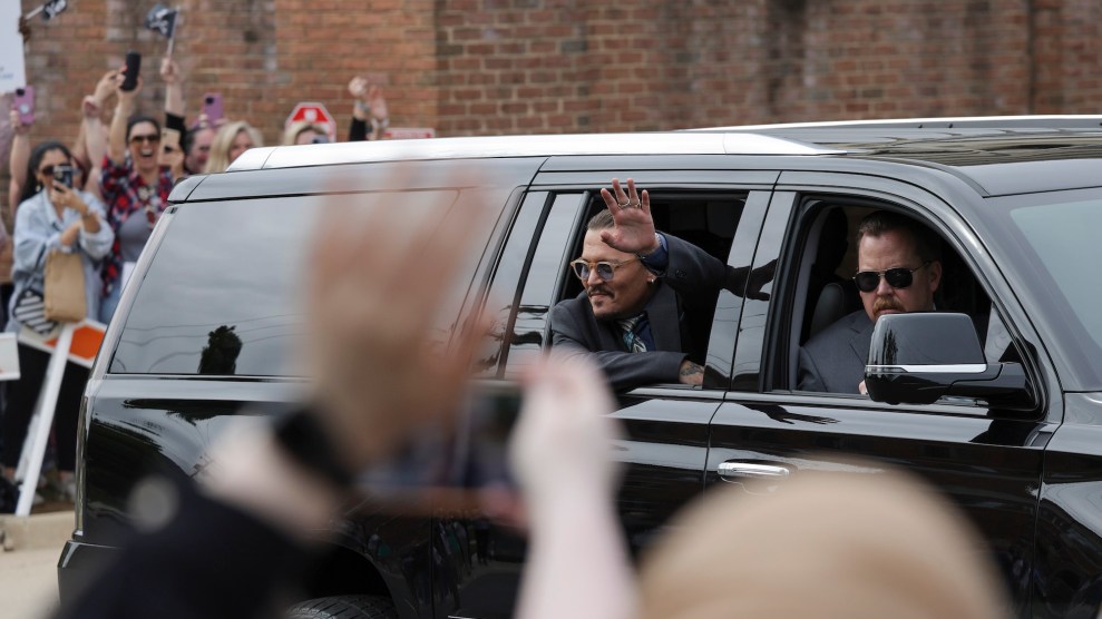 Johnny Depp waves to fans as he leaves the courthouse