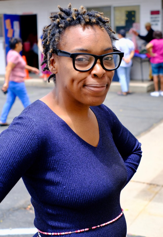 Woman with glasses and blue shirt.