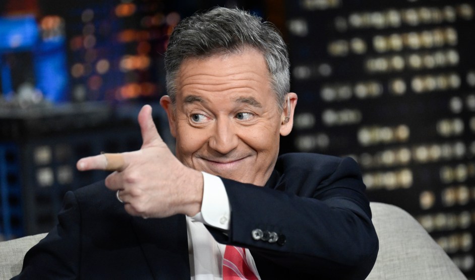 Greg Gutfeld with his finger as a gun and he's smirking