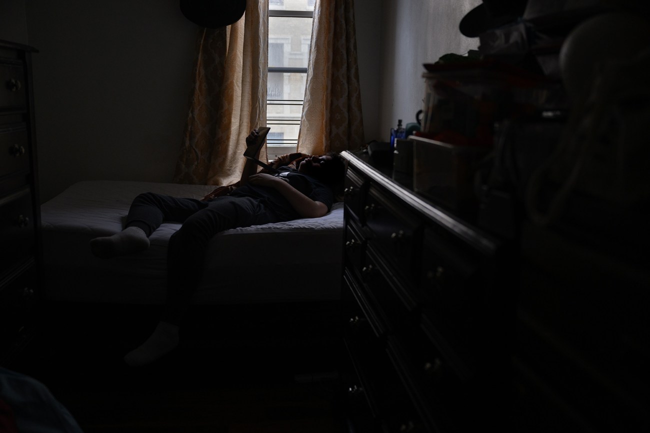 Cristobal watches a television show on a computer in his bedroom.