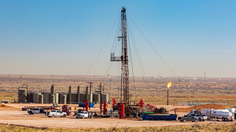 A mechanical structure rises above a vast desert landscape.