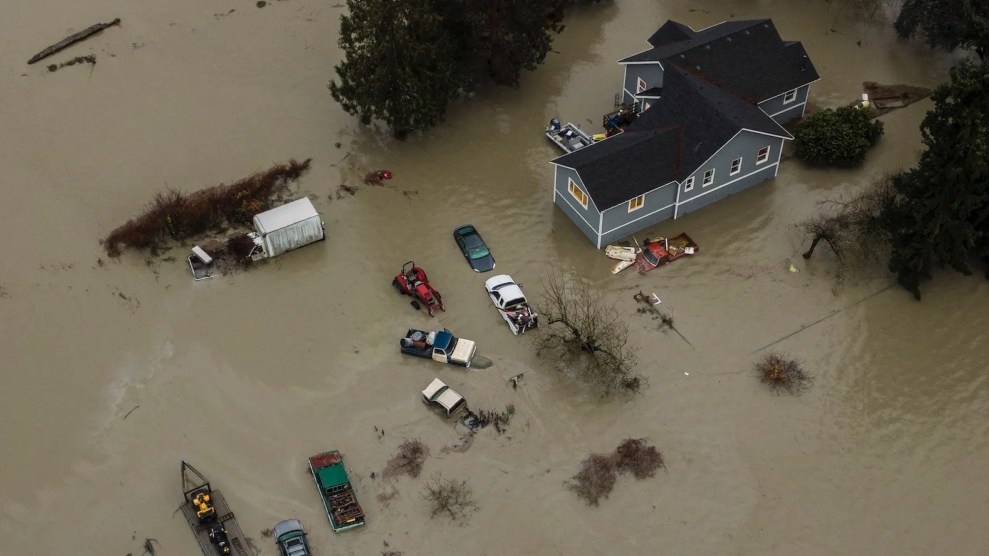 Flooding showing a few cars and a house submerged in water