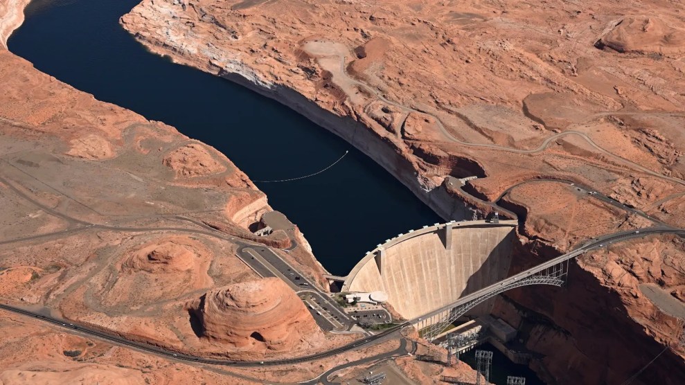 The Colorado Rivo, with a bridge running through it, surrounded by red sand