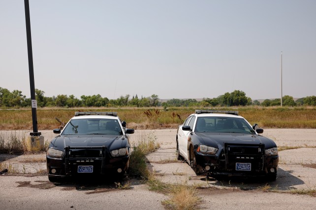 Two police cars in a parking lot.