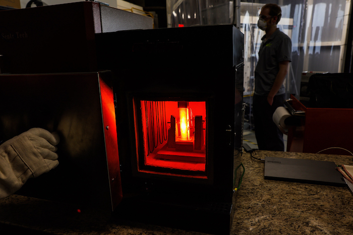 A thermal being heated inside of a brick contraption. 