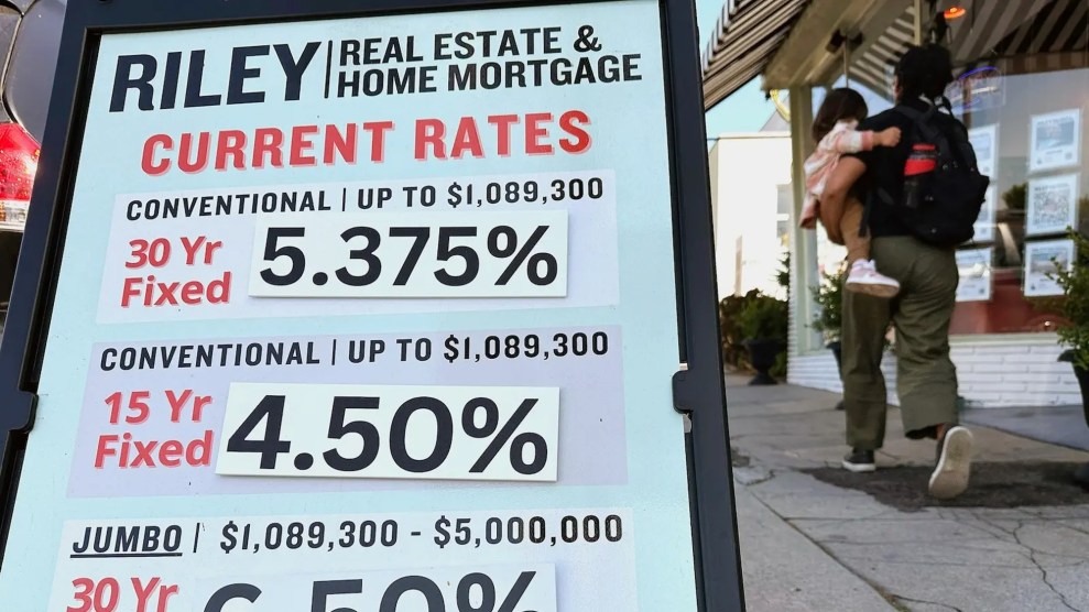 home mortgage rates fill a sign that resides outside a real estate office.