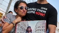 A photo of Rachel Goldberg-Polin holding a picture of her son, Hersh, at a rally to free hostages