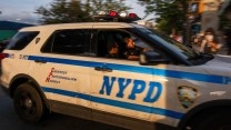 A blue-and-white police car with NYPD on the door