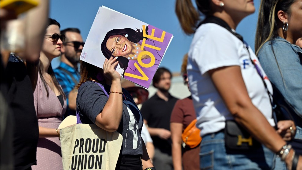 a person holds up a sign to share themself from the sun