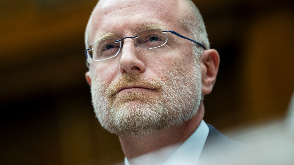 Close-up portrait of FCC Commissioner Brendan Carr—a bespectacled man with a shaved head and a short blonde beard.