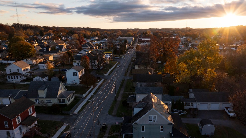 Aerial view of city with sunrising in background.