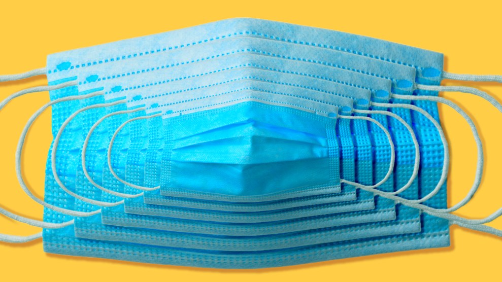 Six blue surgical face masks against a yellow background. Each mask slightly smaller than the one it lies upon.