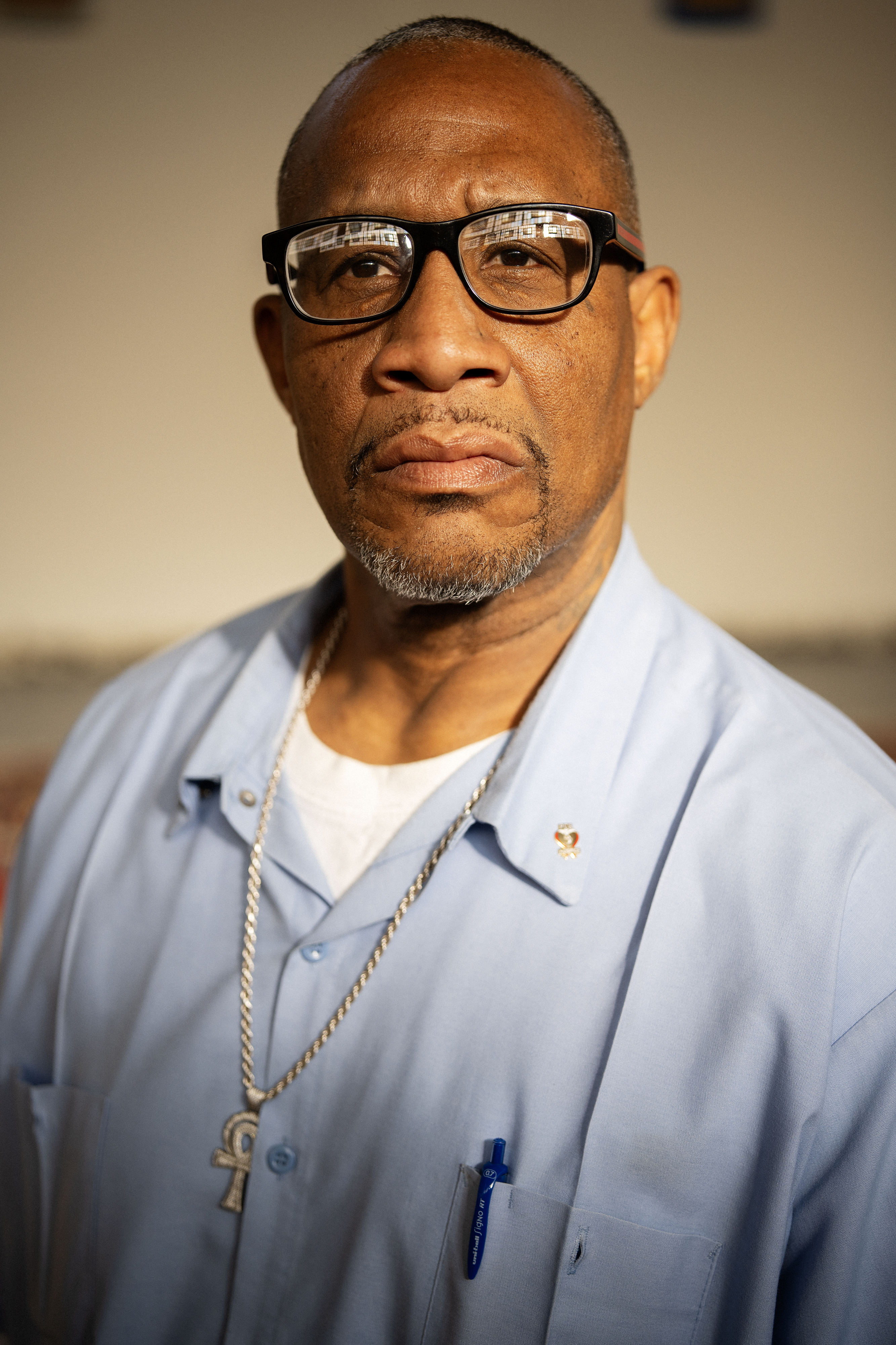 Portrait of a Black man wearing glasses.