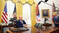 President Donald Trump signs executive orders in the Oval Office.