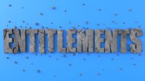 The word "Entitlements' spelled out in all caps in what appears to be stone against a blue background. The stone is greatly fractured with bits of fallen stone scattered around it.