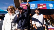 Sen. MarkKelley and Sen. Ruben Gallego pointing at a crowd, a megaphone in Kelley's hand