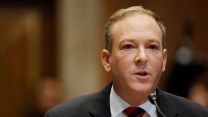 Lee Zeldin's face, framed close up, to the right