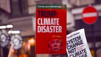 Red sign that says "Trump: Climate Disater"