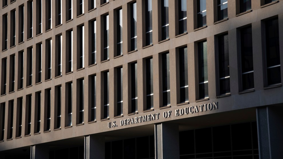 A brown building with large windows that says US Department of Education on it