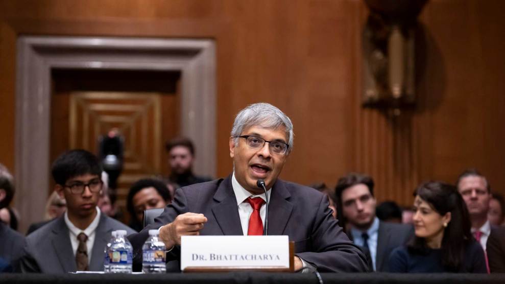 Dr. Jay Bhattacharya sits in front of a microphone as he testifies in his confirmation hearing.