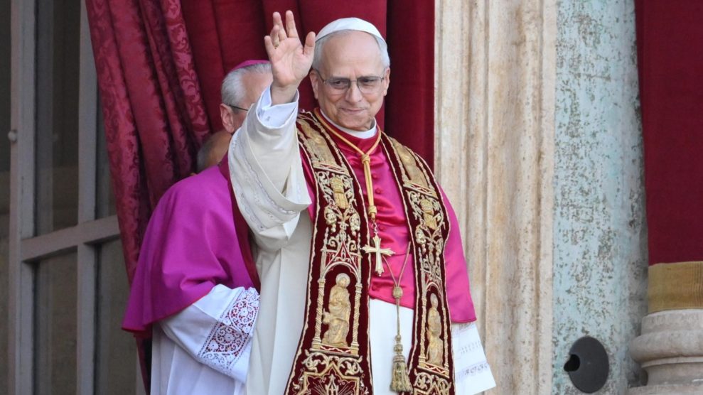 Pope Leo XIV waves to onlookers in Rome.