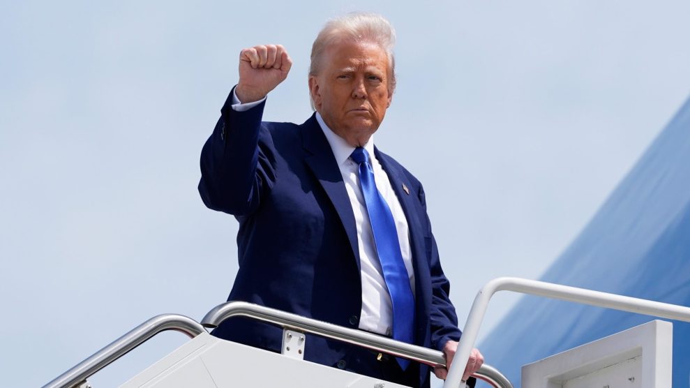 Trump holds up a fist on the jet bridge of Air Force One.