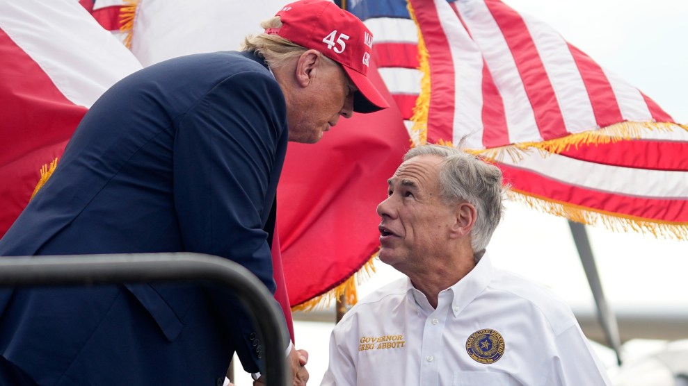 President Donald Trump is shaking hands with Texas Gov. Greg Abbott.