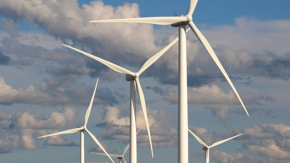 Wind turbines against a cloudy sky.