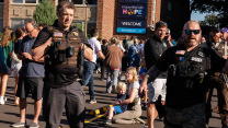 Law enforcement shown in front of the crime scene of the Catholic church in Minneapolis where a mass shooting occurred on August 27, 2025.