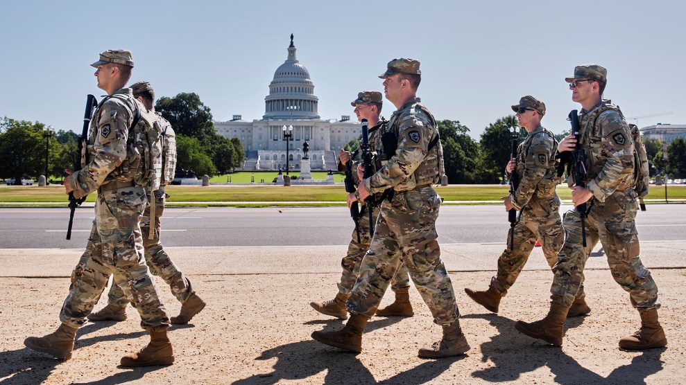 National Guard walking in front of US Capitol building.