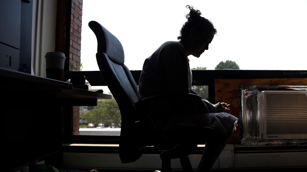 Silhouette of a woman sitting in a chair.