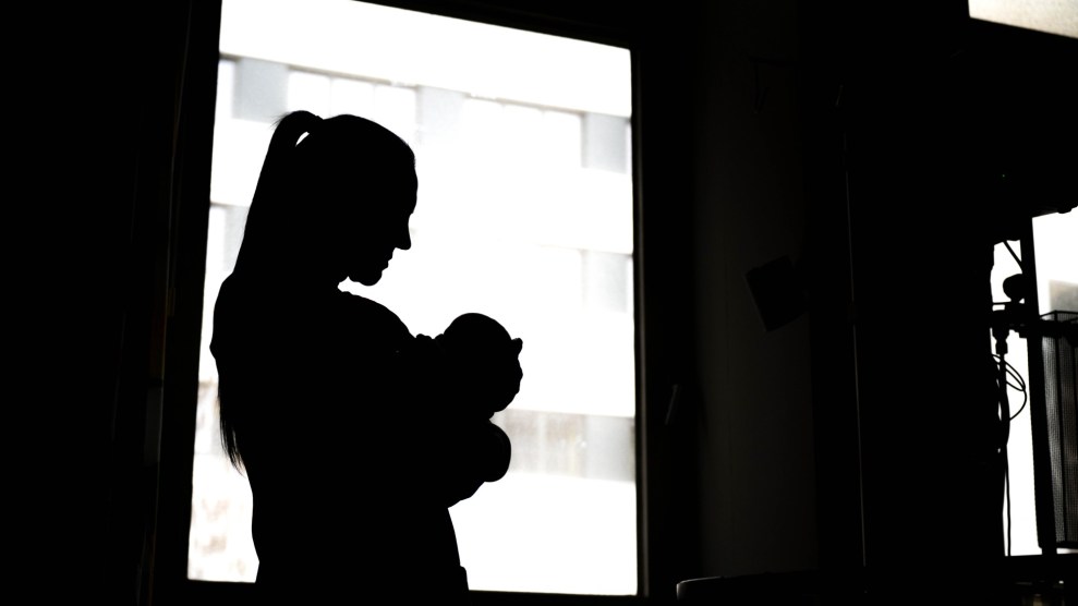 Black and white photo of woman holding baby