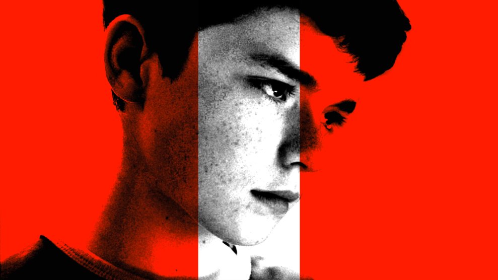 A close-up of a boy’s face, with most of the image in red and black tones except for a black-and-white section in the center