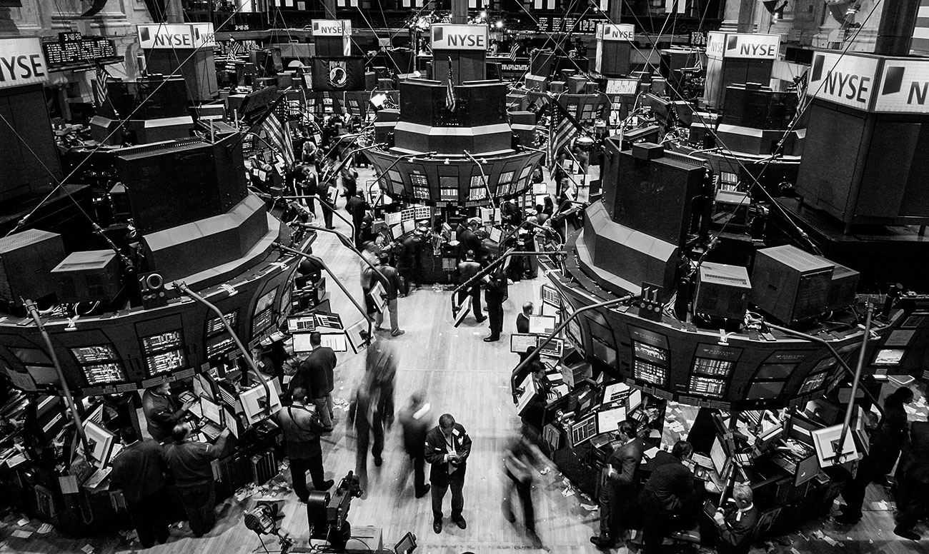 Black-and-white aerial photo of the NYSE trading floor, not terribly crowded.