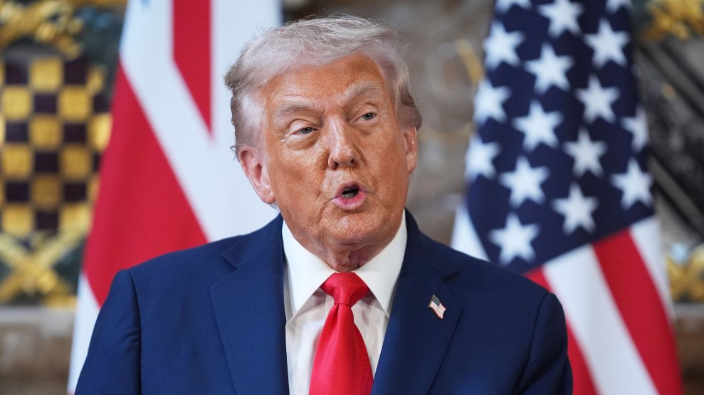 Donald Trump speaking in front of American flags