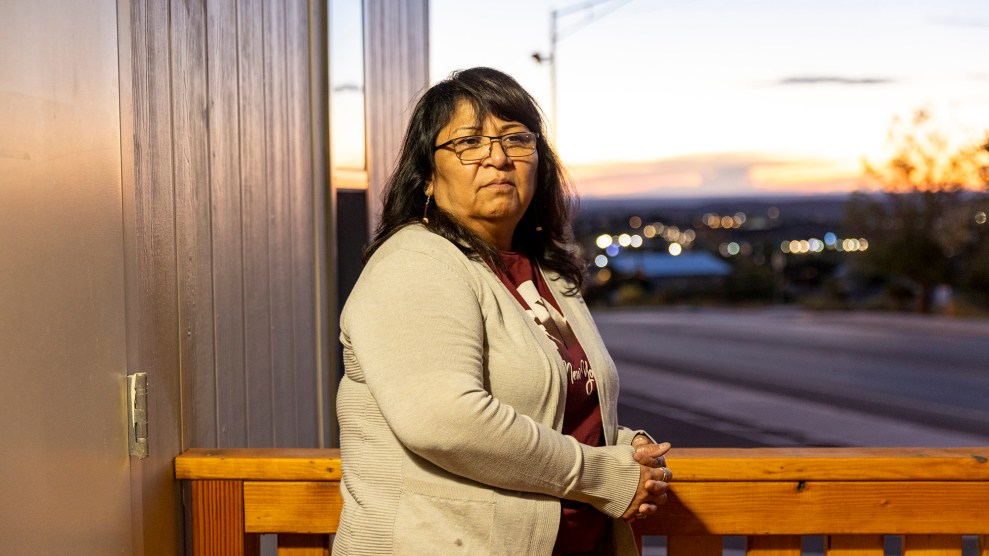 Marlo Kiyite leans against a wooden railing around dusk.