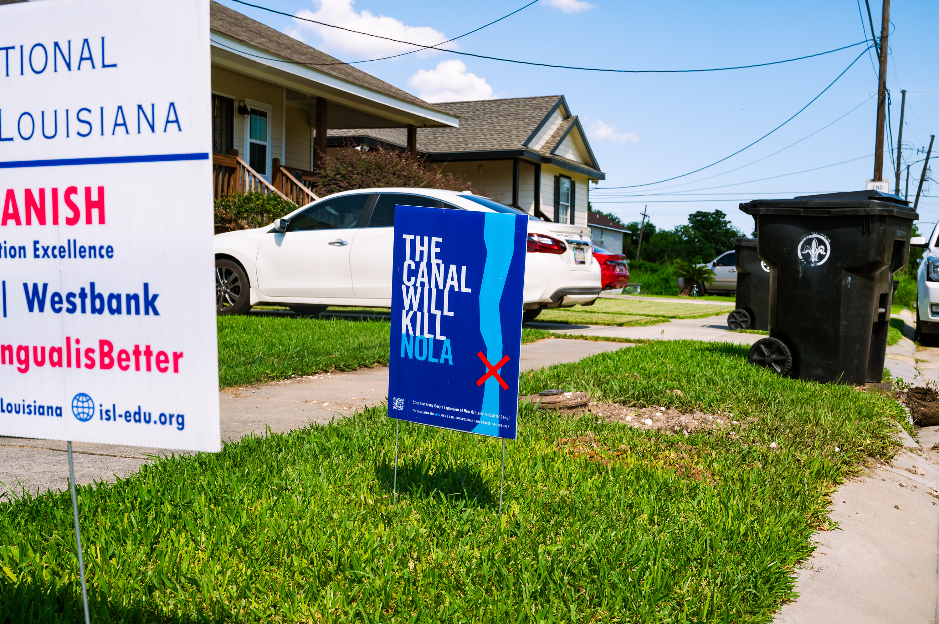 A blue yard sign reads, "The canal will kill NOLA."
