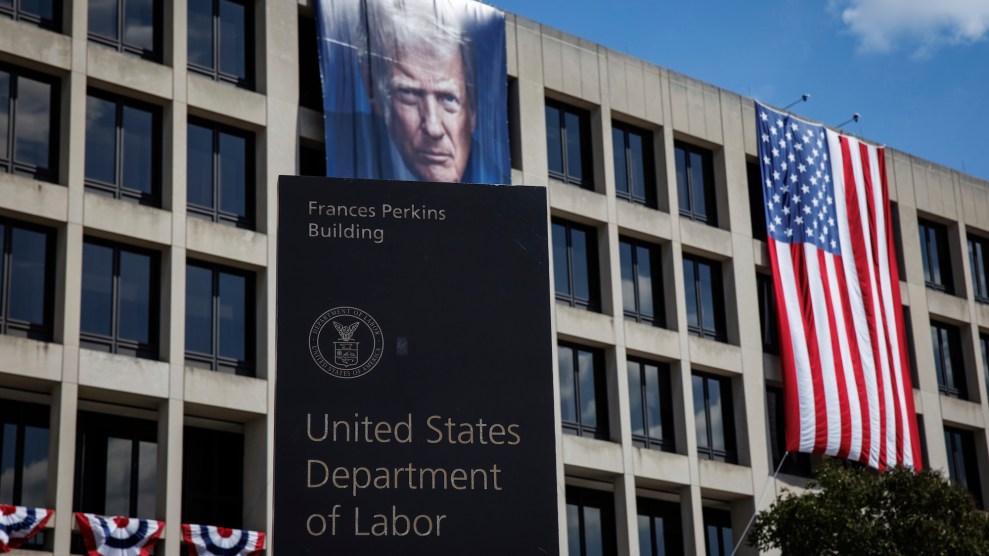 The Department of Labor building with a flag of Trump and an American flag drapping down the building.