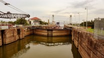 A barge waits in the lock of a canal.