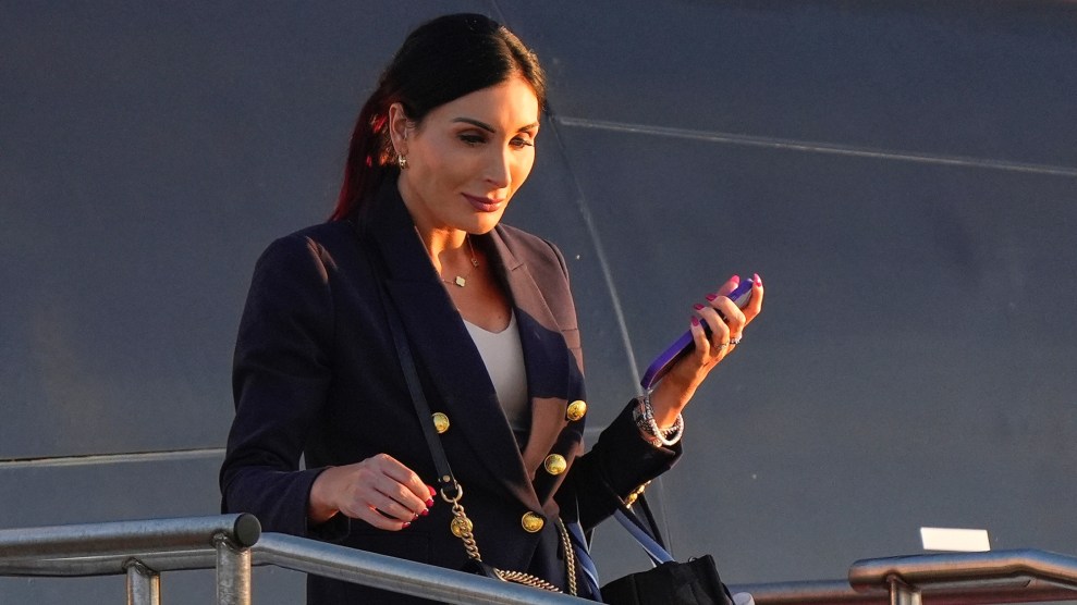 Laura Loomer walks off a plane holding a cell phone