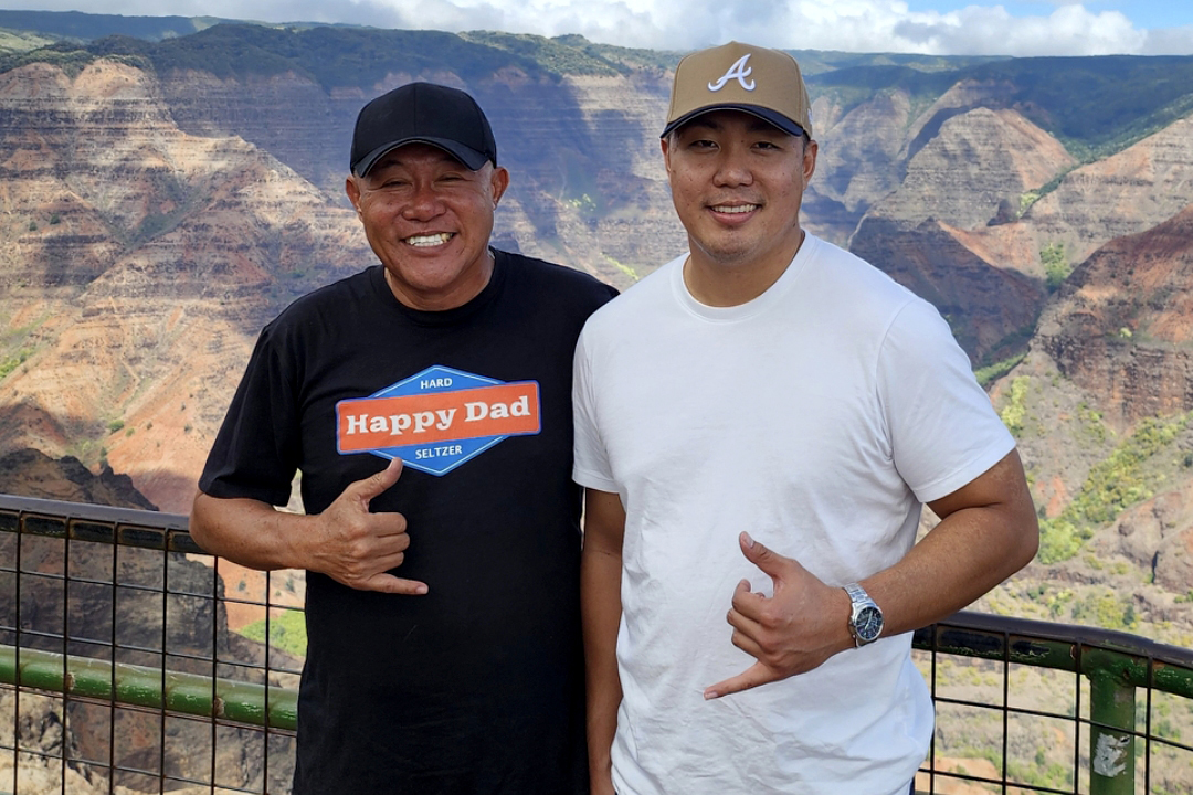 Sae Joon Park stands with his son in front of Waimea Canyon State Park. 