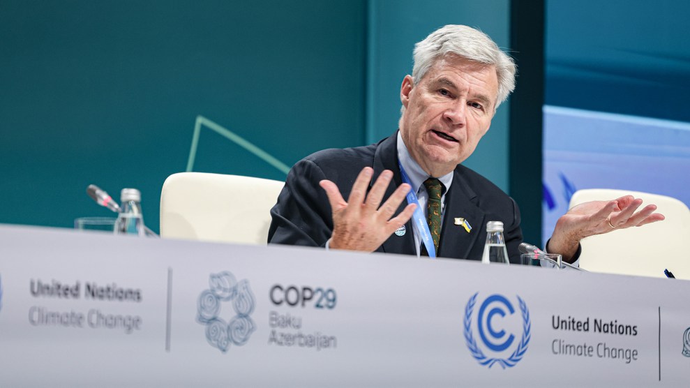 A white man sitting at a table that says "United Nations Climate Change COP29"