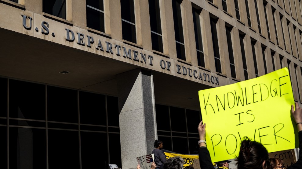 A protest outside the US Department of Education with a sign that says "Knowledge is Power"