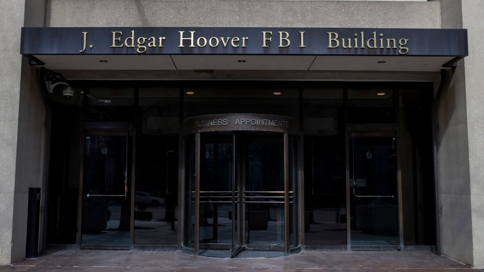 The facade of a building, with the words "J. Edgar Hoover FBI Building" in gold lettering above the entrance