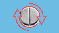 Abortion pill overlaid with two red arrows encircling it, indication a reversal
