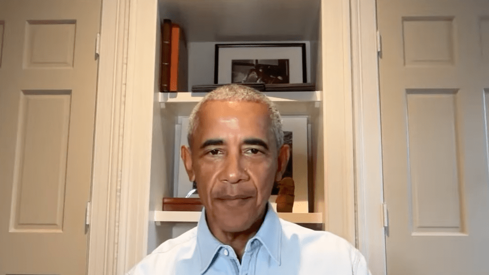 Barack Obama wears a blue collared shirt, and speaks during a live stream.