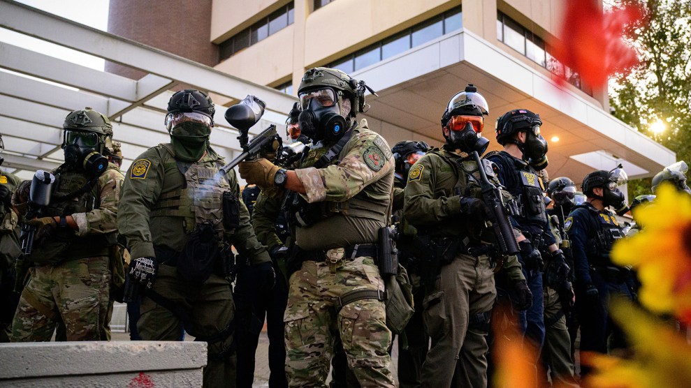 Line of heavily armed and armored federal agents.